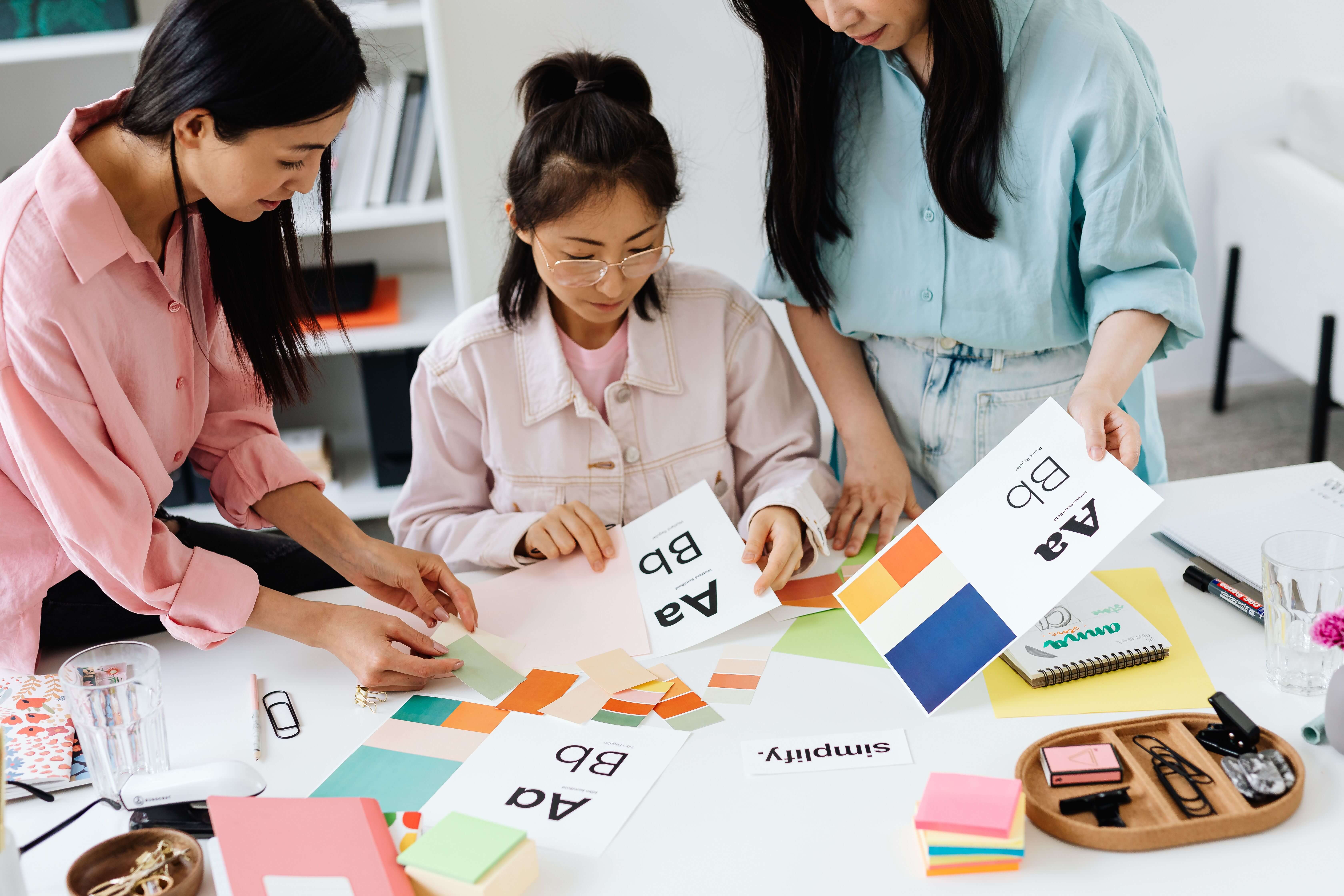 A design studio workspace with mood boards and screens showing different kinds of creative work